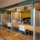 Bilingual reception and patient check-in area featuring custom coordinator stations, privacy partitions and interior finishes.